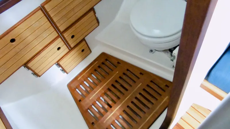 Slide: The Image of 2011 Cape George Cutter bathroom with wooden cabinets and floor mat. - 47