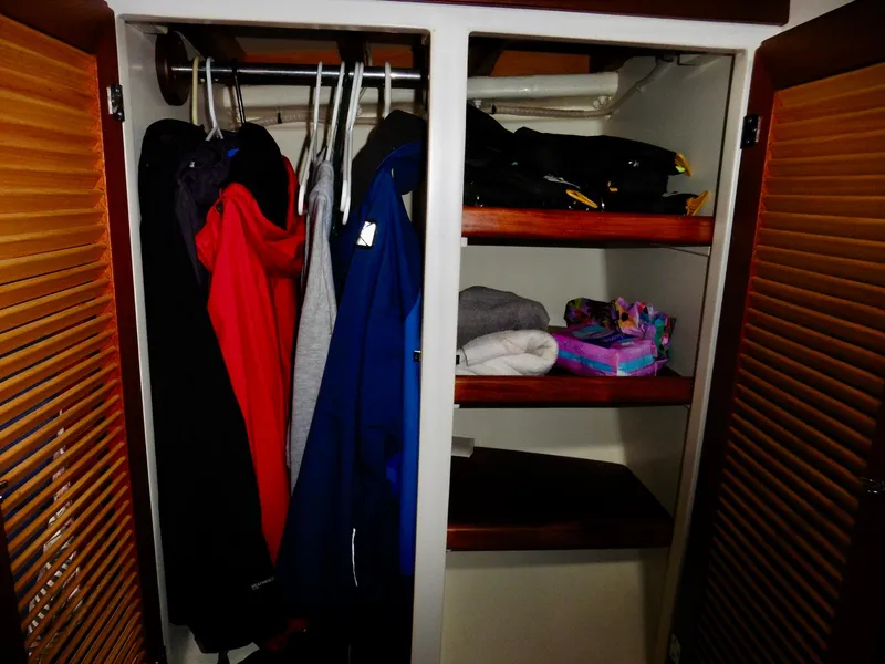 Slide: The Image of Closet interior on 2011 Cape George Cutter with clothes and shelves. - 48