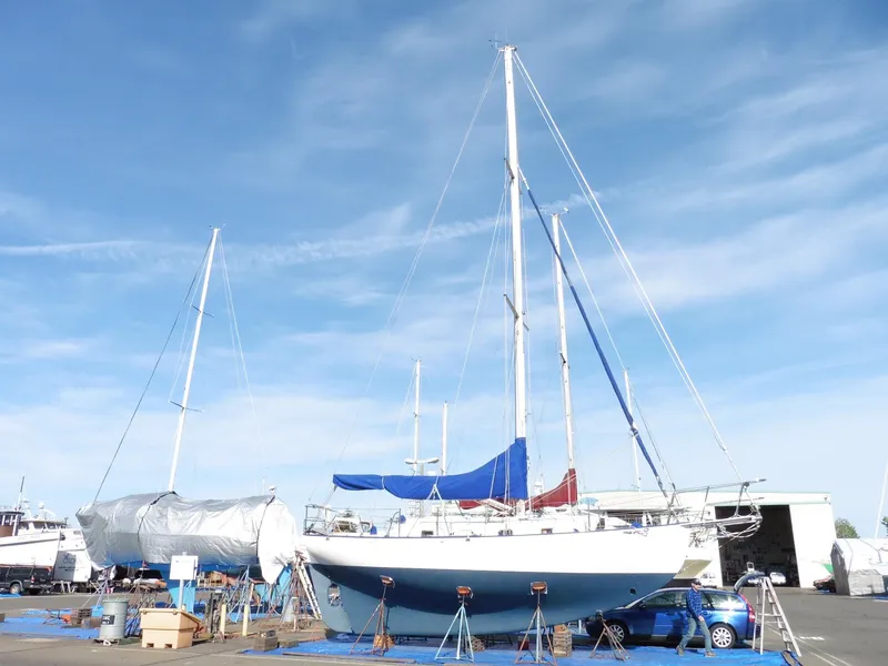 Slide: The Image of 2011 Cape George Cutter sailboat on land, blue sky background, marina setting. - 6