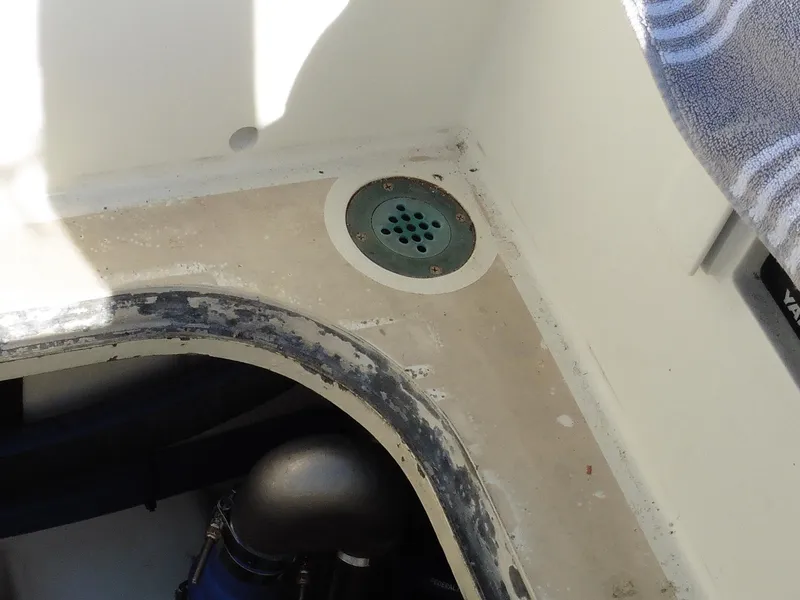 Slide: The Image of Cape George Cutter 2011 boat interior showing a drain and engine compartment. - 9