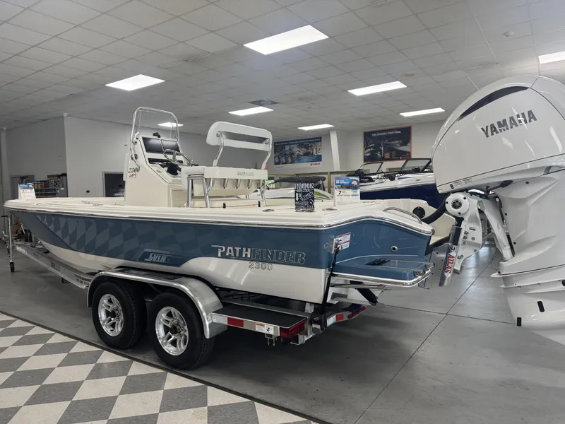 Slide: The Image of 2025 Pathfinder 2300 HPS boat with Yamaha engine in showroom. - 10