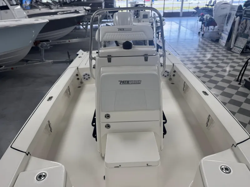 Slide: The Image of 2025 Pathfinder 2300 HPS boat interior in showroom, featuring sleek design and modern amenities. - 3