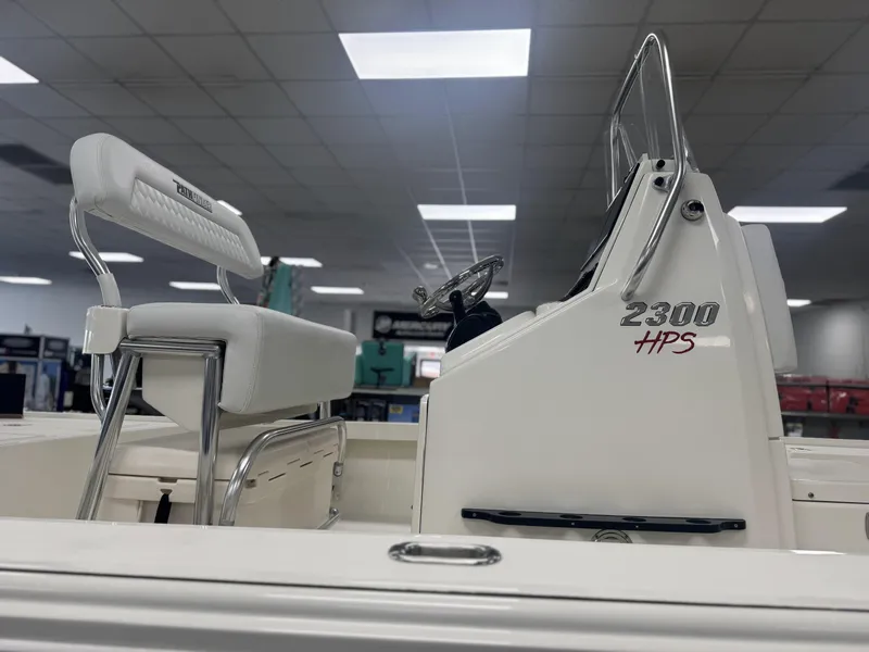 Slide: The Image of 2025 Pathfinder 2300 HPS boat interior with seating and console in showroom. - 4