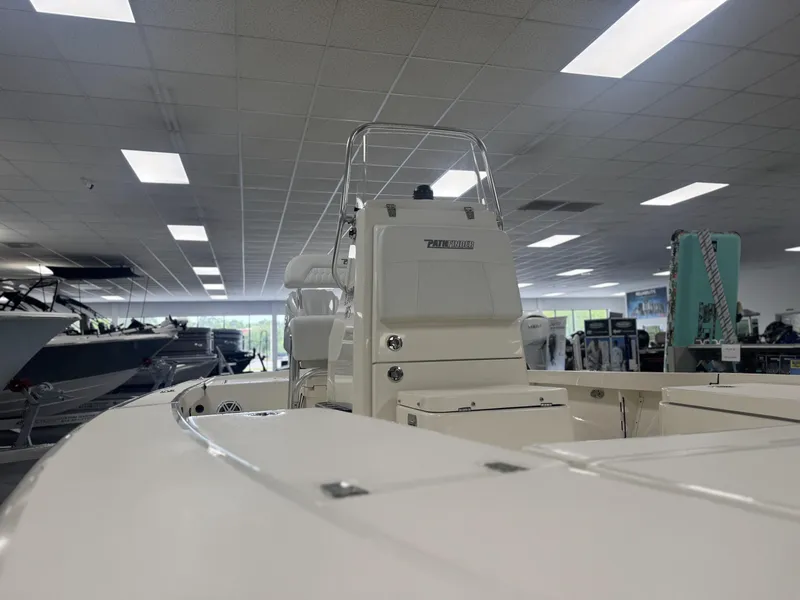 Slide: The Image of 2025 Pathfinder 2300 HPS boat displayed in a showroom with overhead lighting. - 7