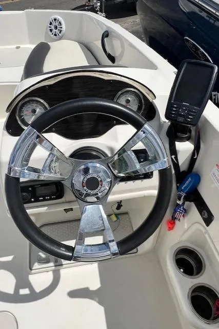 Slide: The Image of 2019 Stingray 182 SC boat dashboard with steering wheel and navigation system. - 1