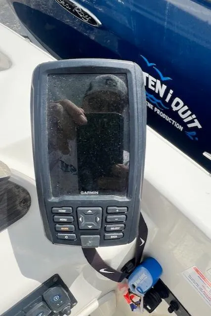 Slide: The Image of Garmin device on 2019 Stingray 182 SC boat dashboard, with blue background. - 2