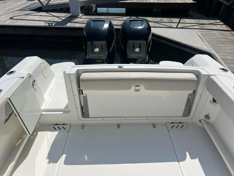 Slide: The Image of 2016 Boston Whaler 270 Vantage boat with dual outboard engines at dock. - 10