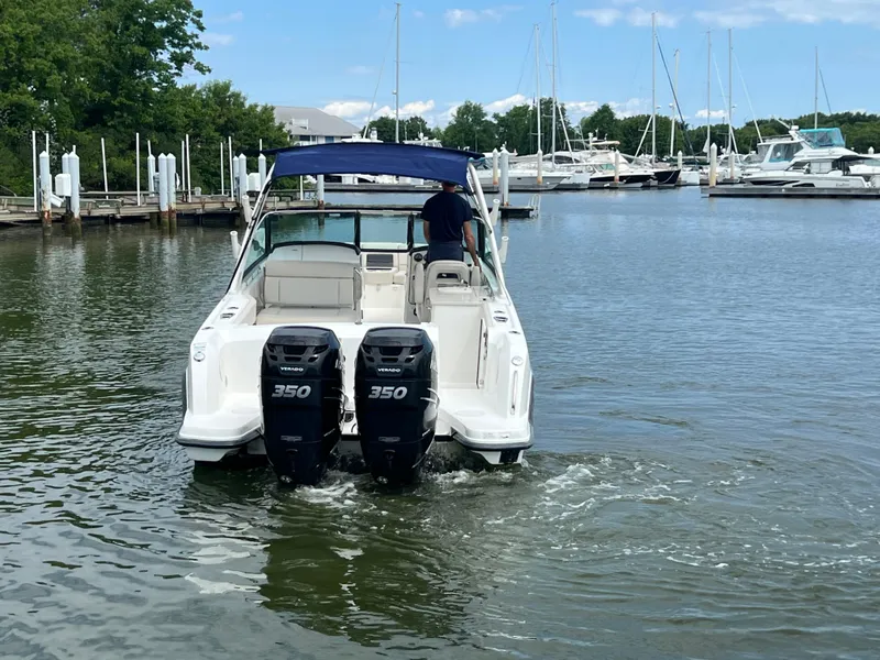 Slide: The Image of 2016 Boston Whaler 270 Vantage boat with twin 350 engines in a marina. - 18