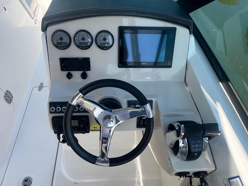 Slide: The Image of Steering console of 2016 Boston Whaler 270 Vantage with gauges and controls. - 6