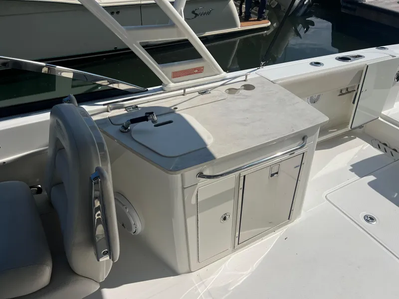 Slide: The Image of 2016 Boston Whaler 270 Vantage boat interior with seating and storage area. - 8