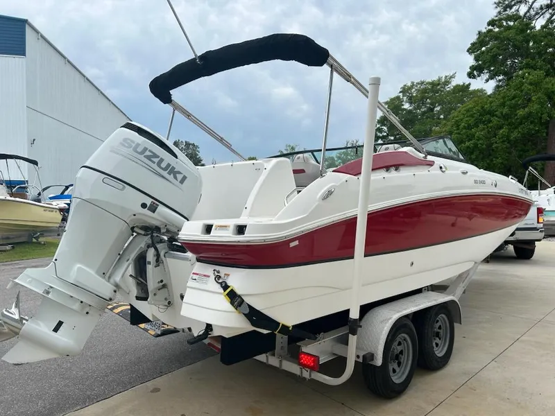 Slide: The Image of 2021 Hurricane SunDeck 2400 OB boat with Suzuki outboard motor on trailer. - 2