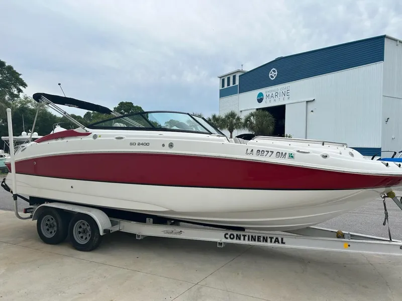 Slide: The Image of 2021 Hurricane SunDeck 2400 OB boat on trailer, parked outside marine facility. - 3