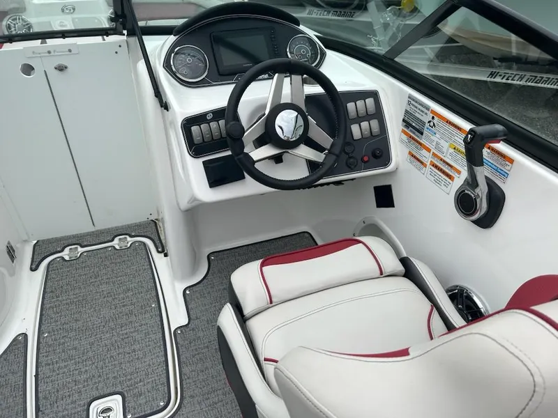 Slide: The Image of 2021 Hurricane SunDeck 2400 OB boat interior with steering wheel and control panel. - 7