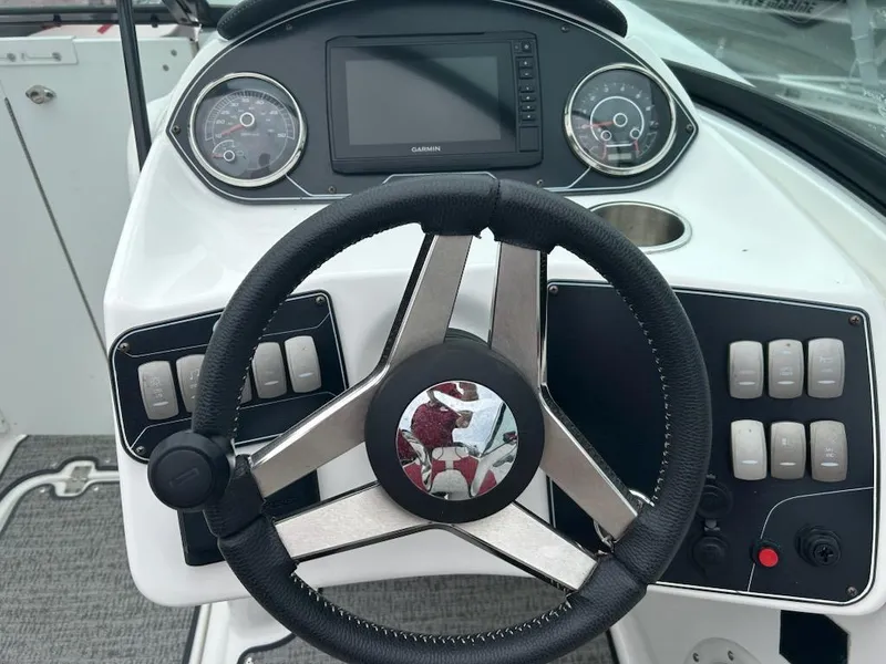 Slide: The Image of 2021 Hurricane SunDeck 2400 OB boat dashboard with steering wheel and control panel. - 8