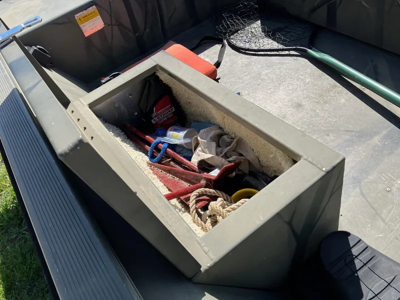 Slide: The Image of Open storage compartment in 2006 Tracker GRIZZLY 1648 AWL boat with tools and supplies. - 12