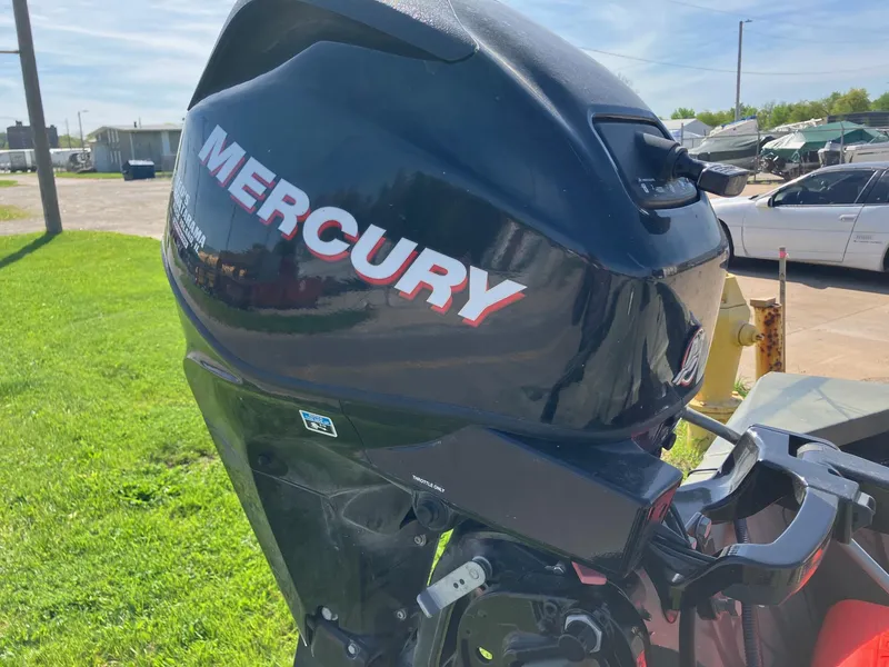 Slide: The Image of Mercury outboard motor on 2006 Tracker GRIZZLY 1648 AWL boat, parked on grass. - 15