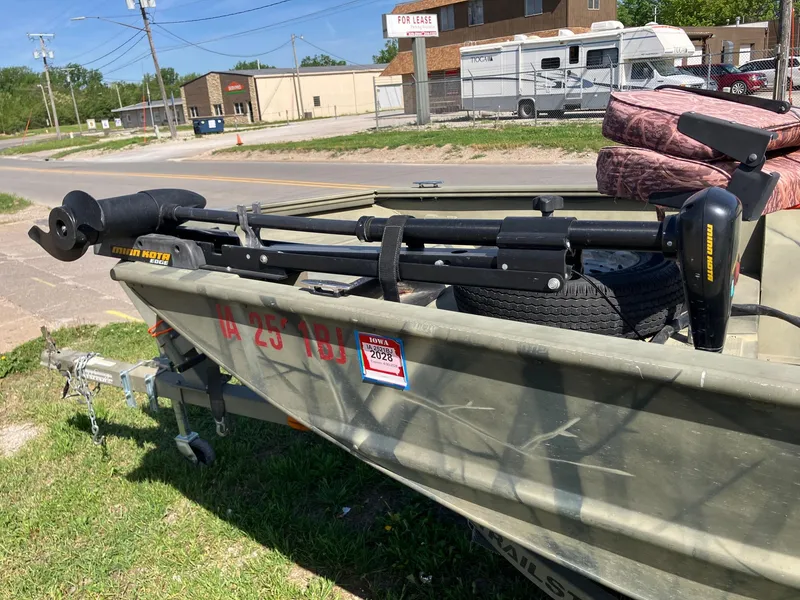 Slide: The Image of 2006 Tracker GRIZZLY 1648 AWL boat with motor, parked on grass near road. - 18
