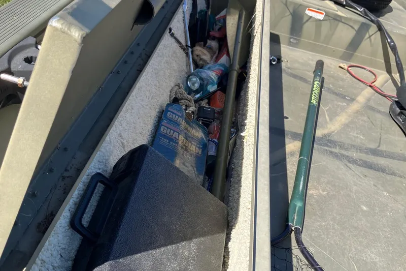 Slide: The Image of Storage compartment of 2006 Tracker GRIZZLY 1648 AWL boat with fishing gear and supplies. - 19