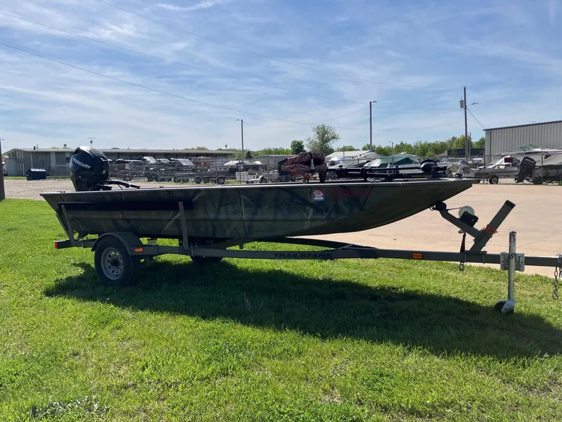 Slide: The Image of 2006 Tracker GRIZZLY 1648 AWL boat on trailer, parked on grass under clear sky. - 3