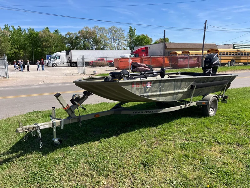 Slide: The Image of 2006 Tracker GRIZZLY 1648 AWL boat on trailer, parked on grass near road. - 6