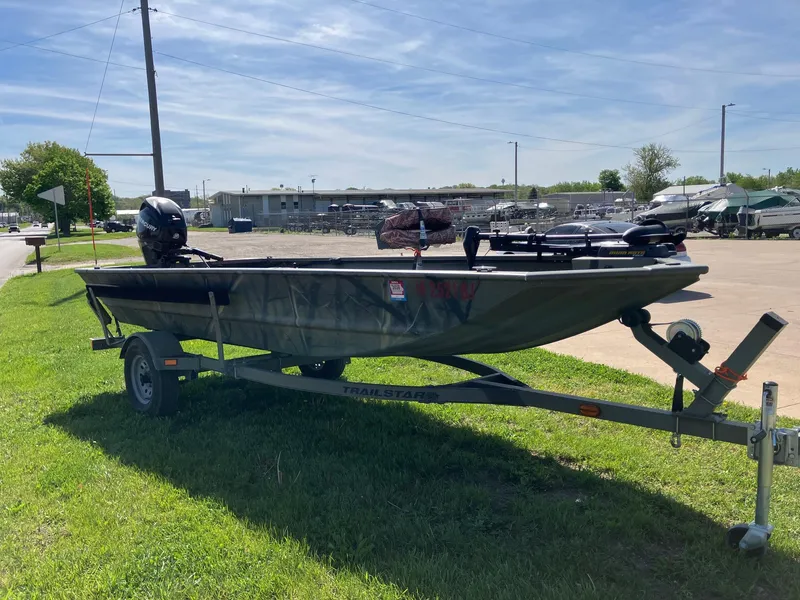 Slide: The Image of 2006 Tracker GRIZZLY 1648 AWL boat on trailer, parked on grass under clear sky. - 9