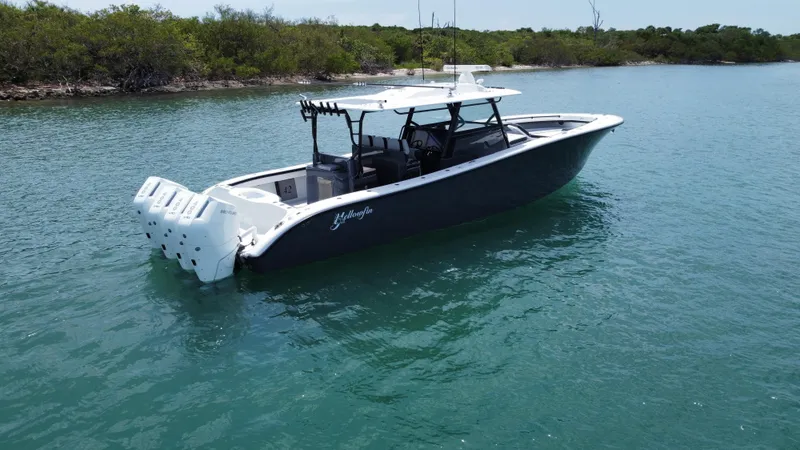 Slide: The Image of 2023 Yellowfin 42 boat on calm water, featuring sleek design and powerful engines. - 0