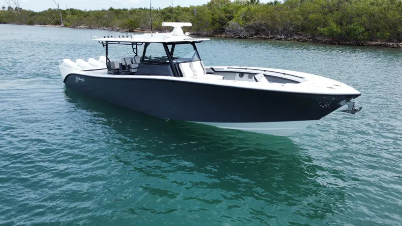 Slide: The Image of 2023 Yellowfin 42 boat cruising on clear blue water. - 1