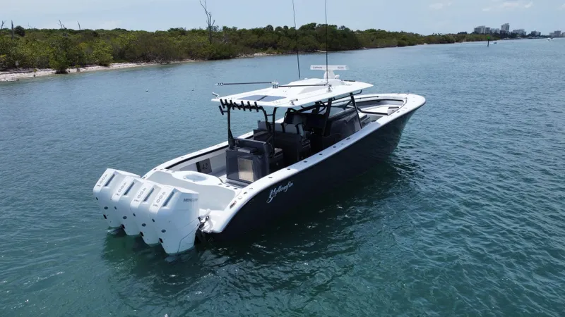 Slide: The Image of 2023 Yellowfin 42 boat with four engines on calm water. - 15