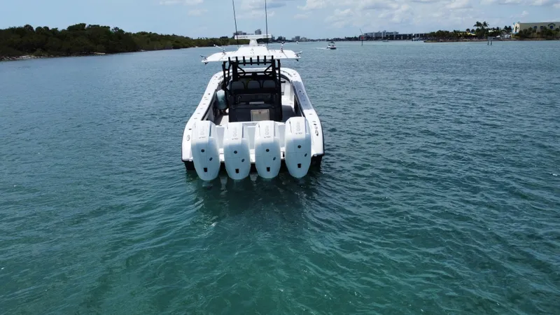 Slide: The Image of 2023 Yellowfin 42 boat with four engines on calm water. - 16