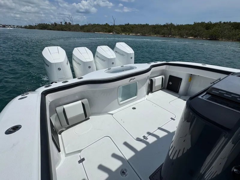 Slide: The Image of 2023 Yellowfin 42 boat with multiple outboard engines on a calm waterway. - 20