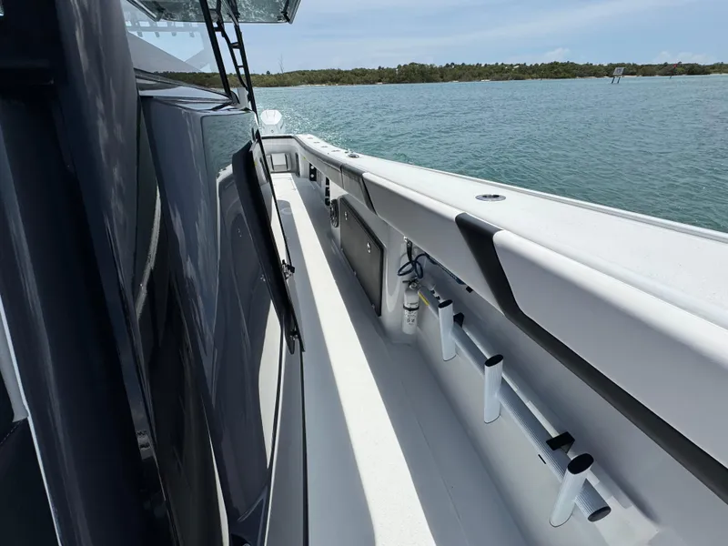Slide: The Image of 2023 Yellowfin 42 boat deck with rod holders, on calm water. - 24