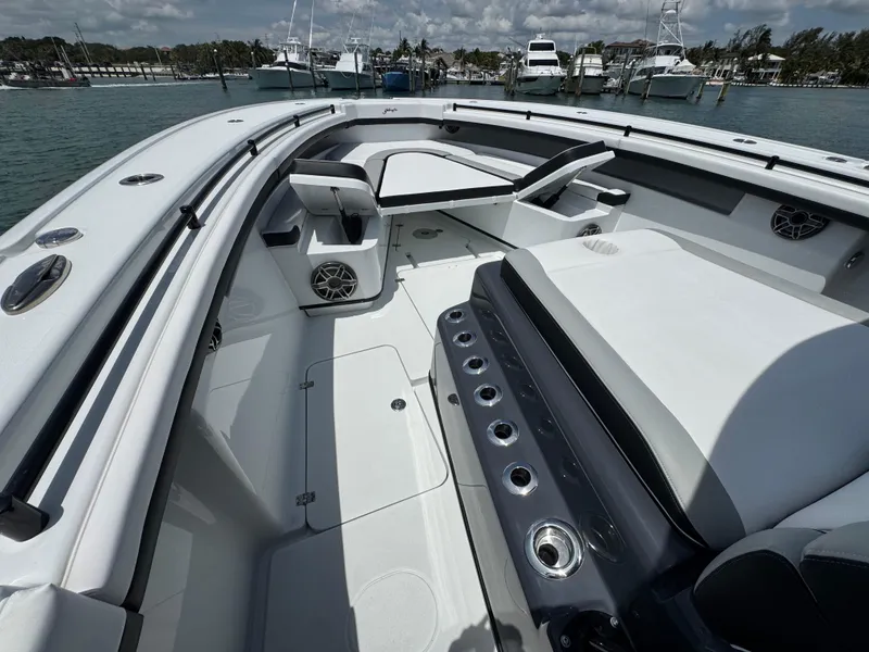 Slide: The Image of 2023 Yellowfin 42 boat interior with seating and cup holders, docked in a marina. - 25