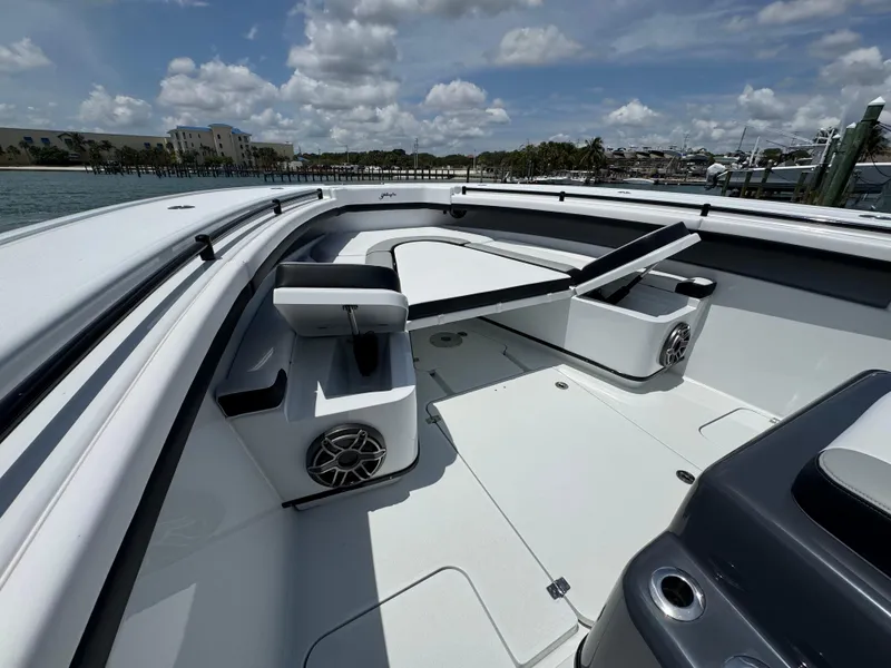 Slide: The Image of 2023 Yellowfin 42 boat interior with seating and speakers, under a partly cloudy sky. - 28