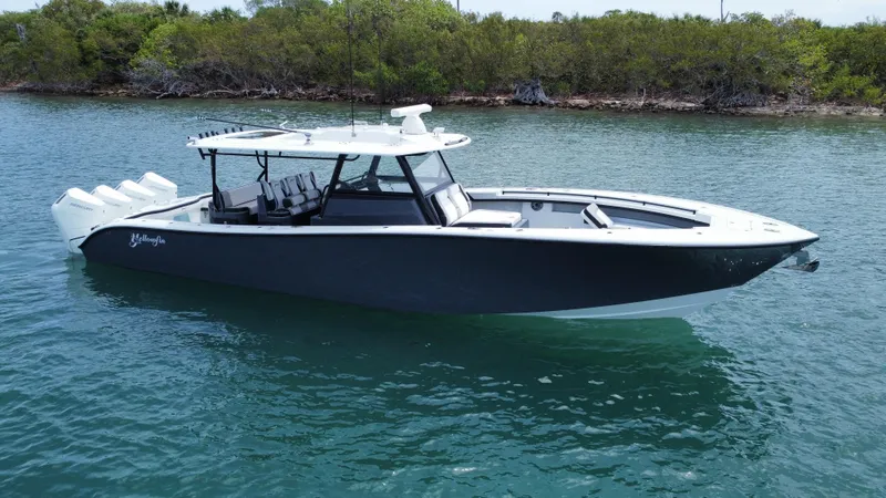 Slide: The Image of 2023 Yellowfin 42 boat on calm water, featuring sleek design and modern amenities. - 3