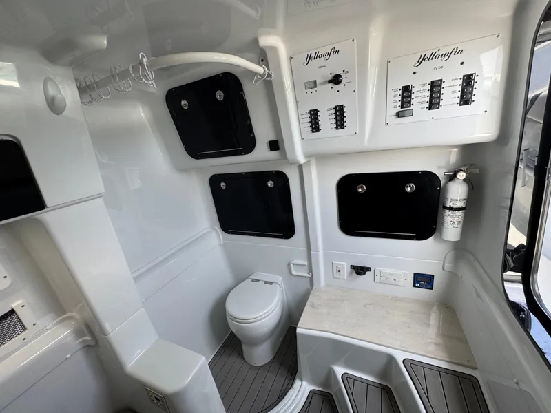 Slide: The Image of 2023 Yellowfin 42 boat interior with toilet, control panels, and fire extinguisher. - 33