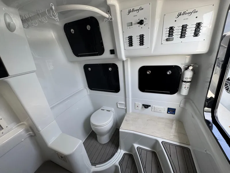 Slide: The Image of 2023 Yellowfin 42 boat interior with toilet, control panels, and fire extinguisher. - 34