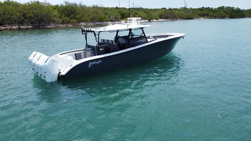 Slide: The Image of 2023 Yellowfin 42 boat on calm water, featuring sleek design and powerful engines. - 4