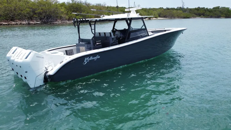 Slide: The Image of 2023 Yellowfin 42 boat on clear water, featuring sleek design and powerful engines. - 5