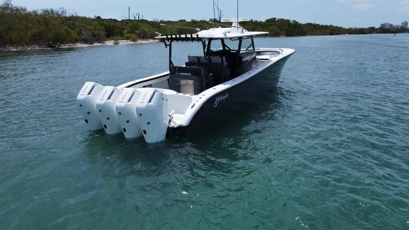 Slide: The Image of 2023 Yellowfin 42 boat with multiple engines on calm water. - 6