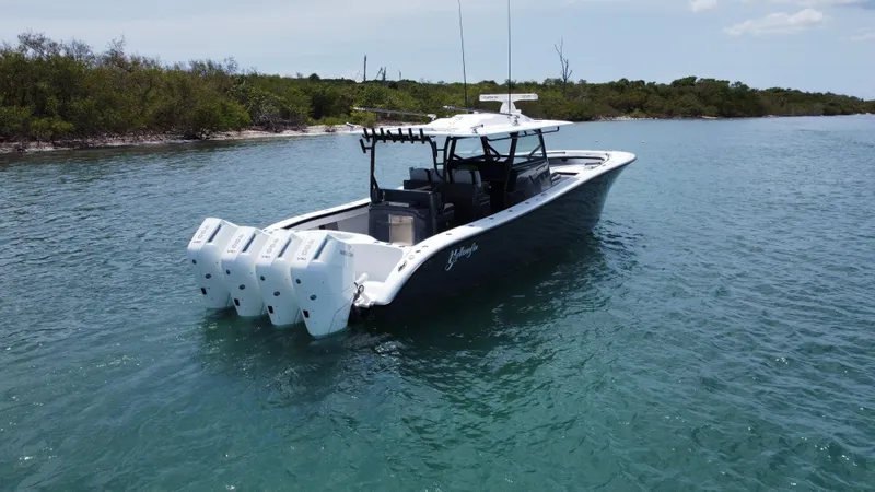 Slide: The Image of 2023 Yellowfin 42 boat with multiple engines on calm water. - 8