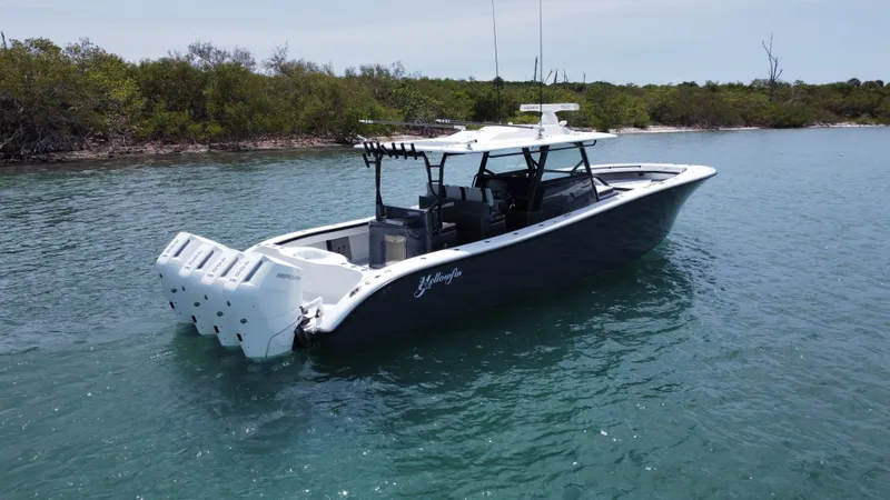 Slide: The Image of 2023 Yellowfin 42 boat with multiple engines on calm water. - 9