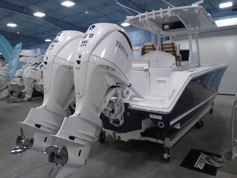 Slide: The Image of 2026 Jupiter 30 boat with dual Yamaha outboard engines in showroom. - 13