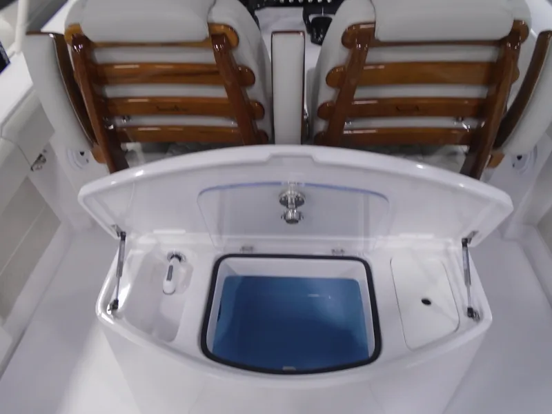 Slide: The Image of Jupiter 30 boat interior with open storage compartment, featuring wooden seat backs, 2026 model. - 20