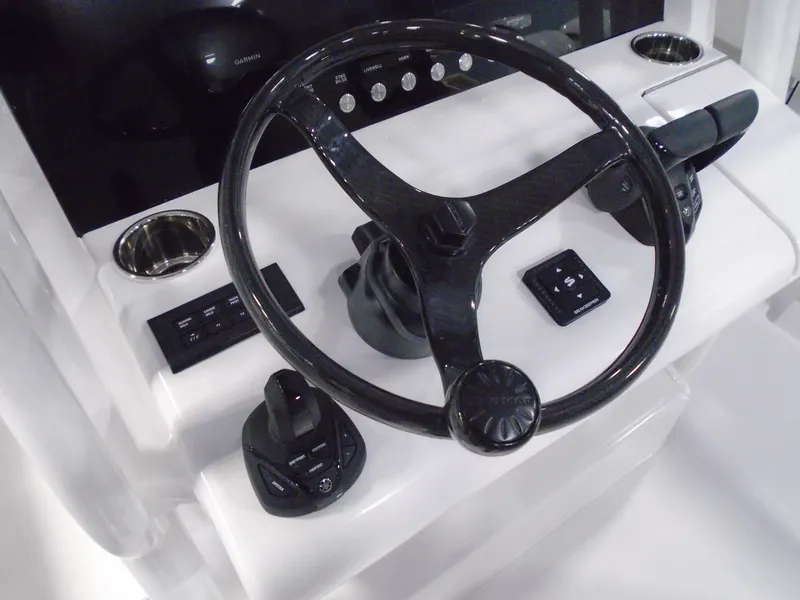 Slide: The Image of Steering console of 2026 Jupiter 30 boat with modern controls and sleek design. - 26