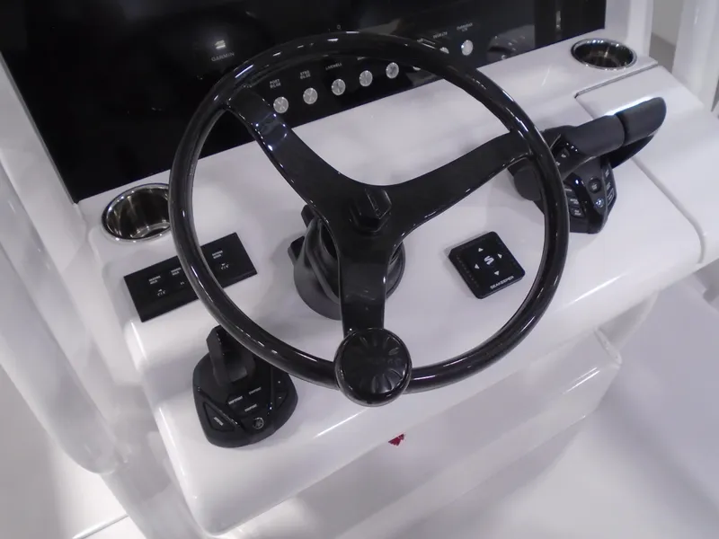 Slide: The Image of Steering console of 2026 Jupiter 30 boat with modern controls and sleek design. - 27