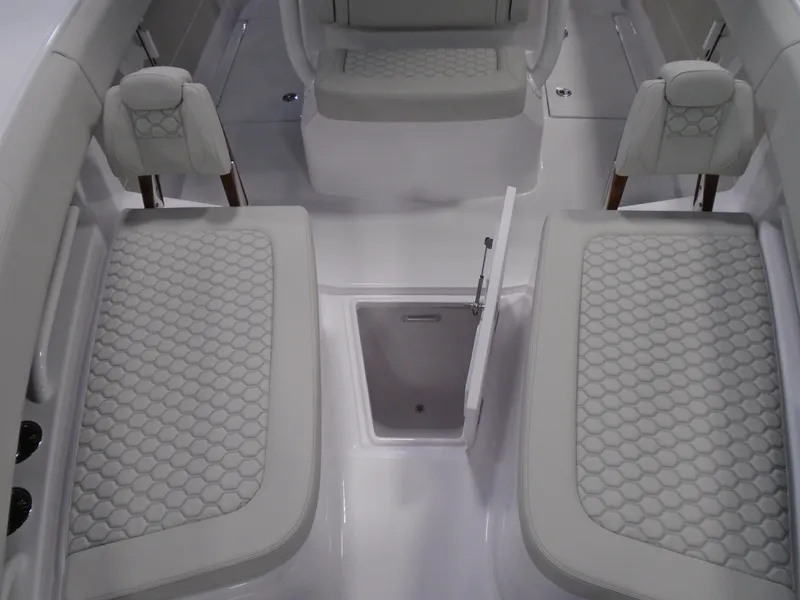 Slide: The Image of 2026 Jupiter 30 boat interior with cushioned seating and storage compartment. - 30