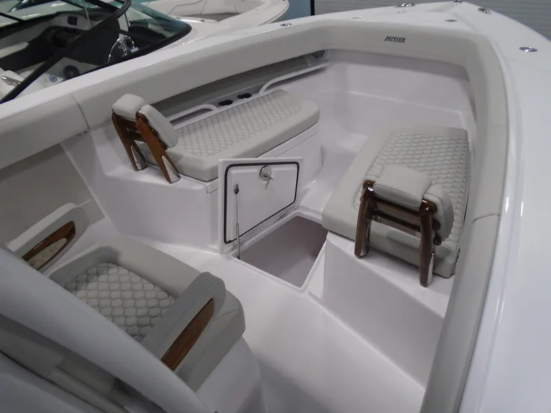 Slide: The Image of 2026 Jupiter 30 boat interior with cushioned seating and storage compartment. - 32