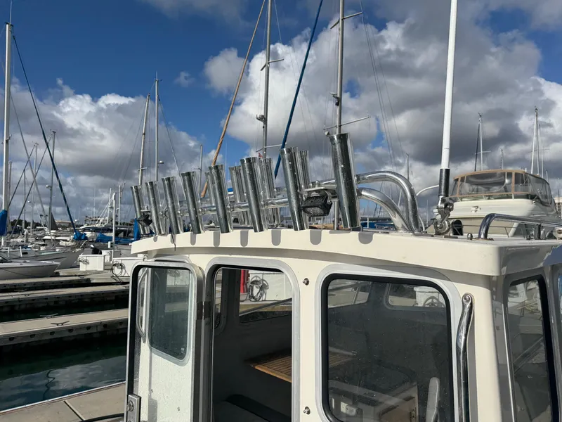 Slide: The Image of 2024 Defiance San Juan 220 boat docked at marina under cloudy sky. - 20