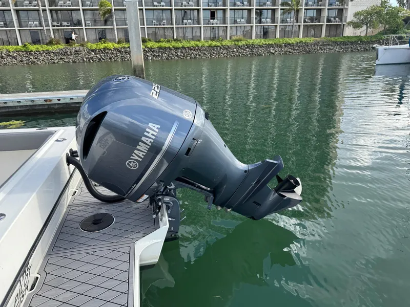 Slide: The Image of 2024 Defiance San Juan 220 with Yamaha outboard motor docked by waterfront. - 7