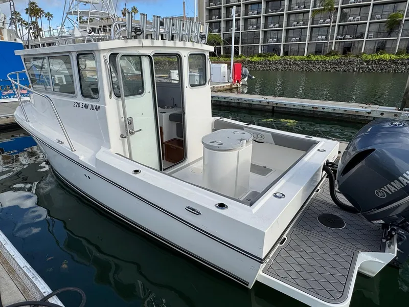 Slide: The Image of 2024 Defiance San Juan 220 boat docked with Yamaha outboard motor. - 8